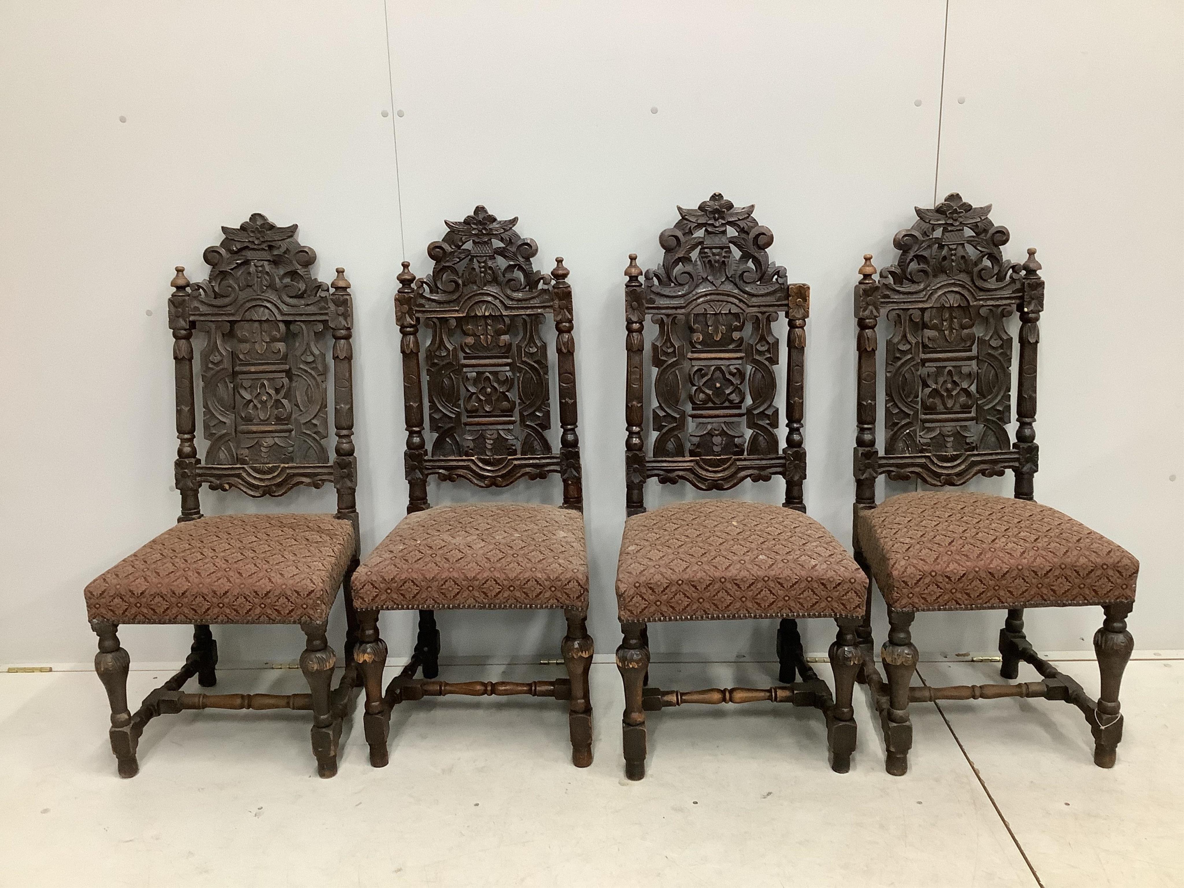 A set of thirteen carved Victorian oak dining chairs, one with arms. Condition - poor to fair
